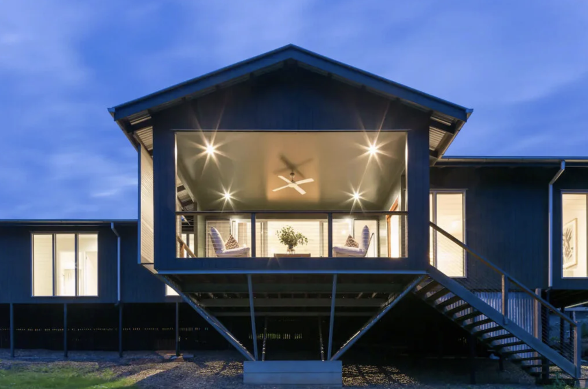 Modern house with a balcony illuminated at dusk