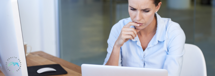 Professional employee reviewing work from home safety information, representing employer responsibilities around hybrid work, wellbeing and psychosocial risk.