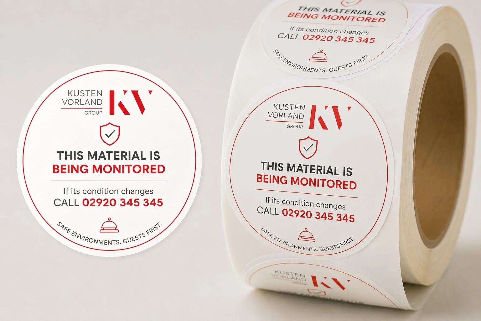 Roll of circular stickers with red and black text that reads "This material is being monitored," with a phone number for updates, and a logo with "Kusten Vorland Group" at the top.