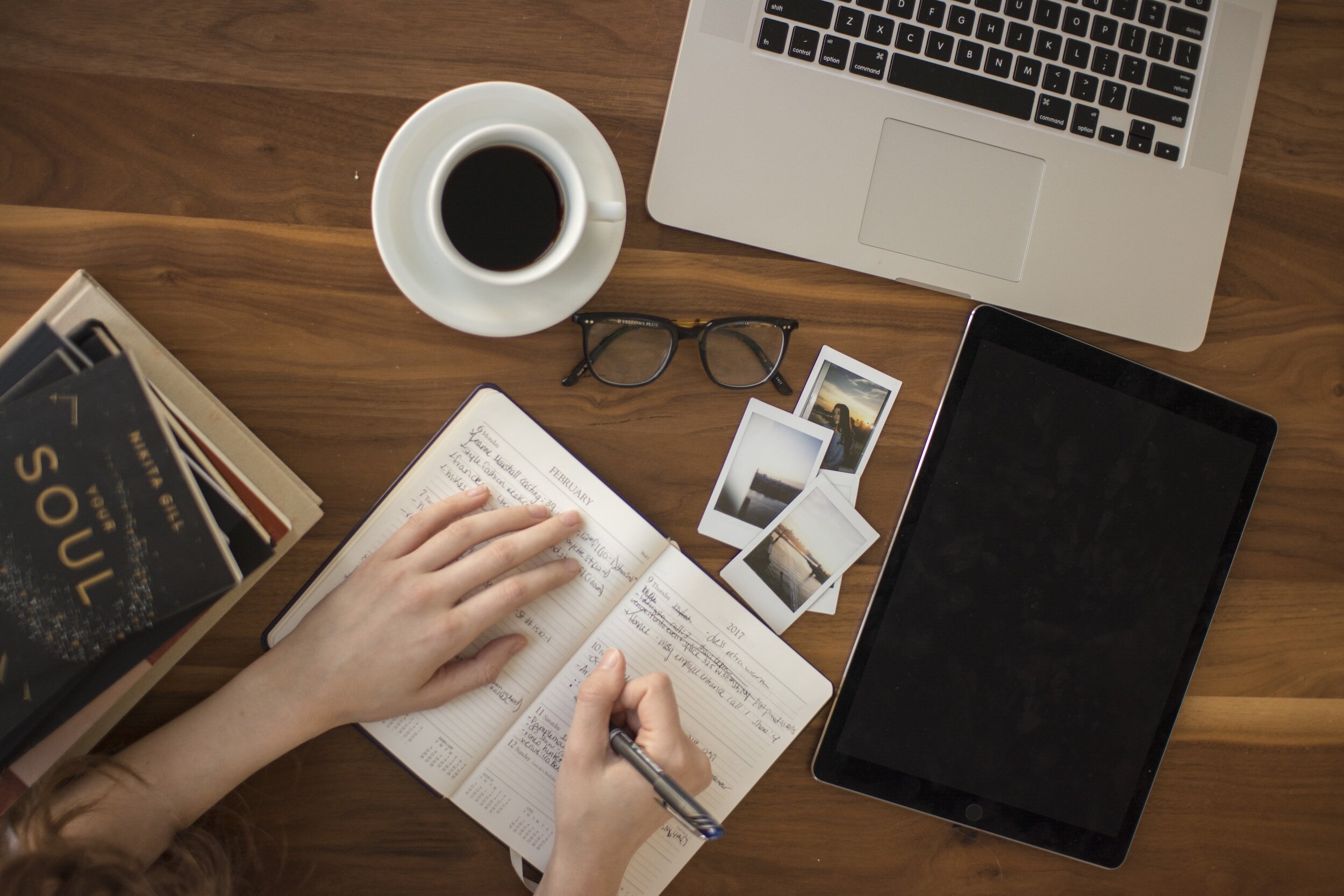 Close up of a work desk with a cup of coffee and a work book. Psychology, Assessment, Therapy, ADHD, Autism, Neurodiversity, Social work, Social care, Advocacy, Family, Self esteem, Anxiety, Stress, Depression, Mental health, EHCP