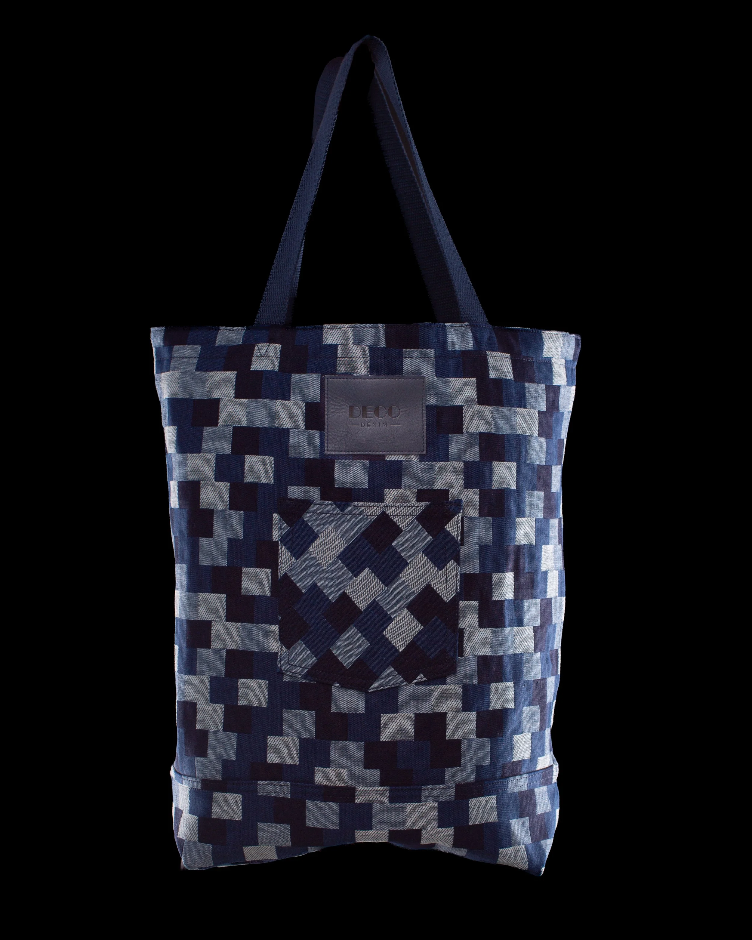 Blue and white geometric-patterned tote bag on a black background.