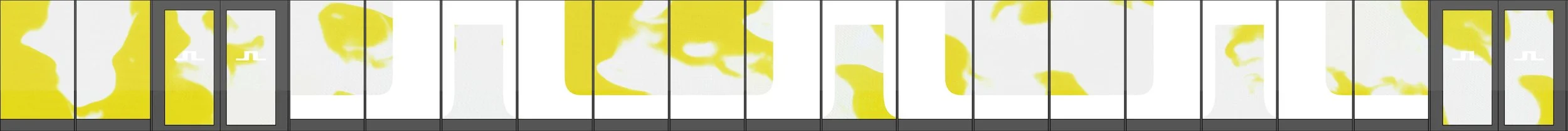 A colorfully painted mural with abstract yellow shapes on a white background, covering a long wall.