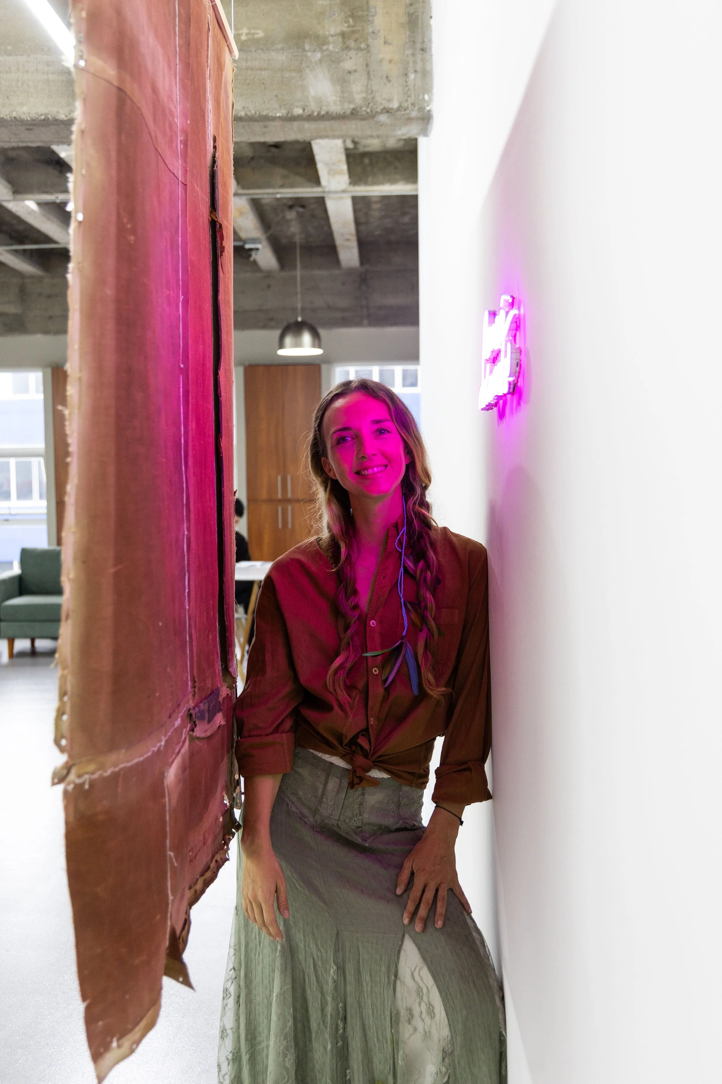 portrait of Carla de Tezanos leaning against exhibition wall