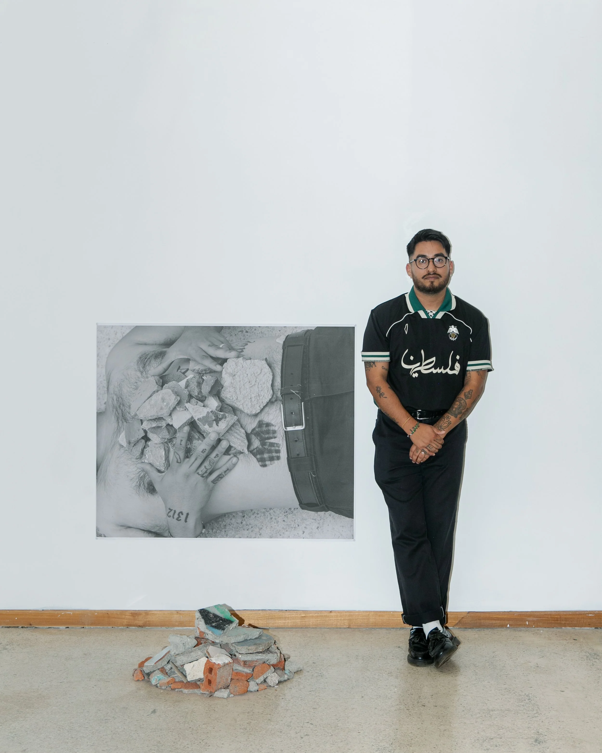Photo of photographer William Camargo in a gallery showing his work