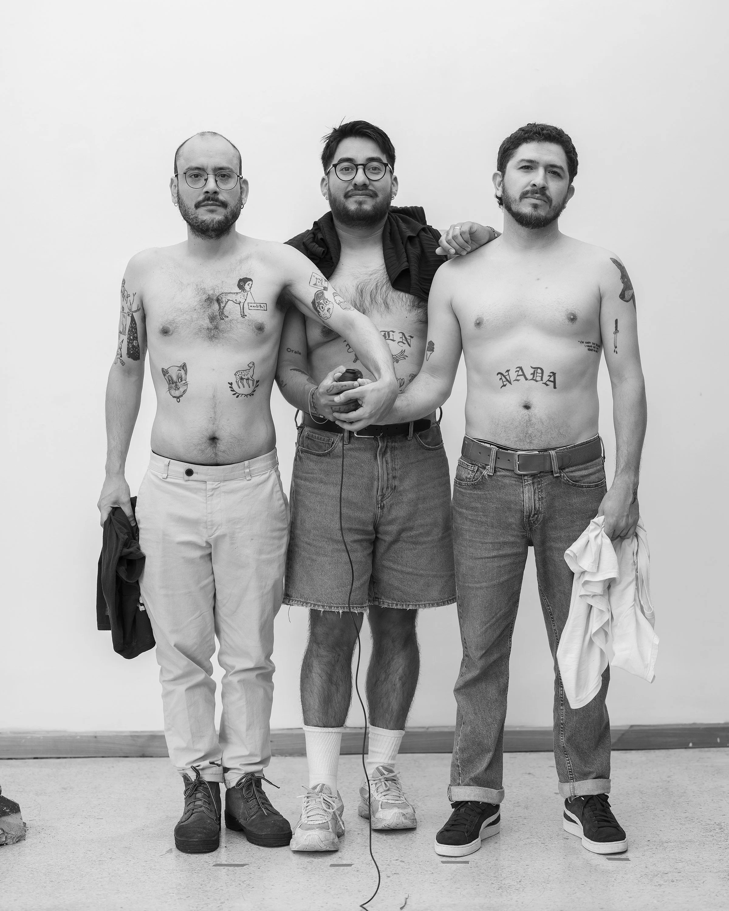 Black and white photo of three young men with tattoos by William Camargo