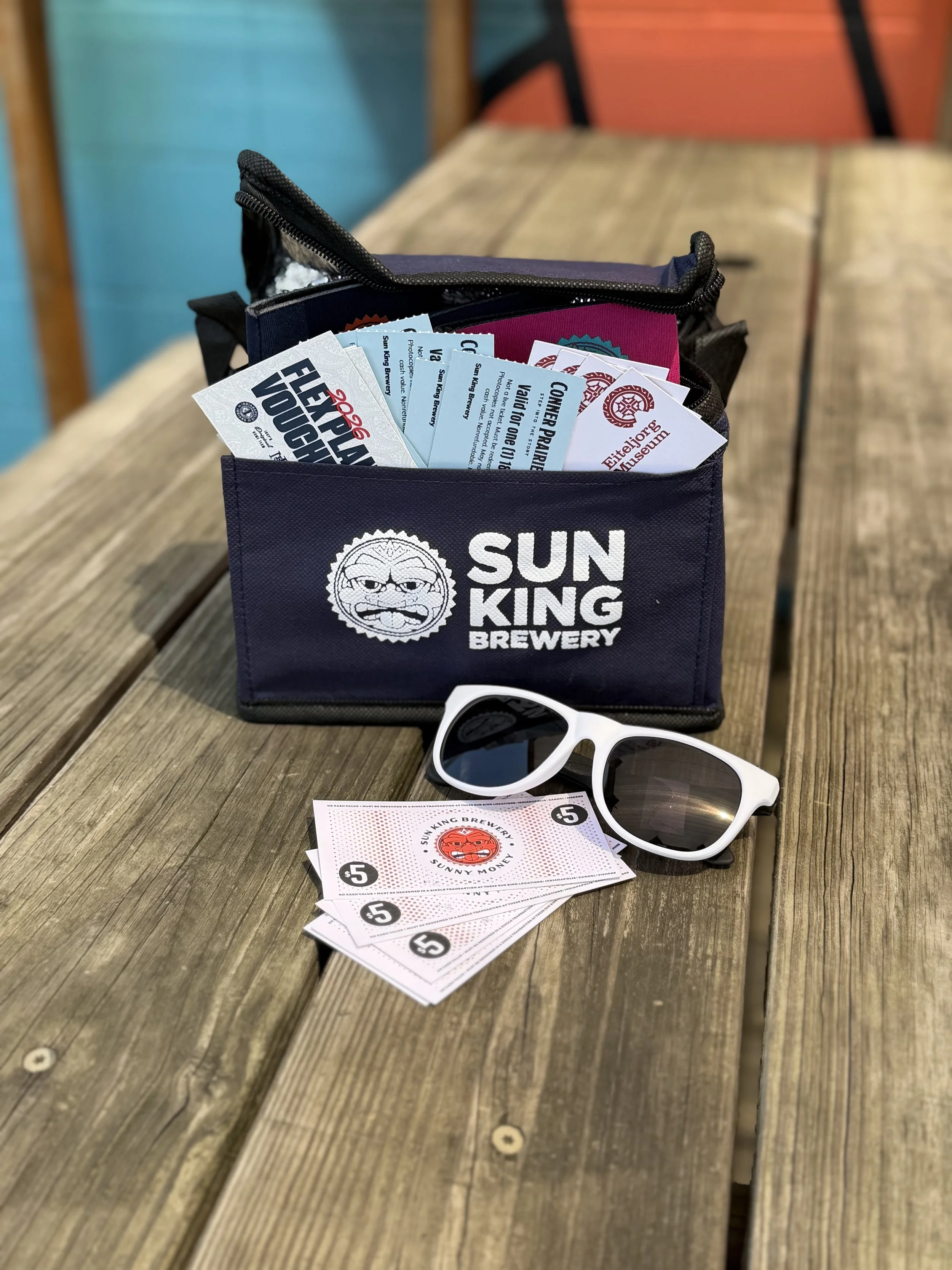 Sun King lunch cooler filled with tickets, can coolers and sunglasses