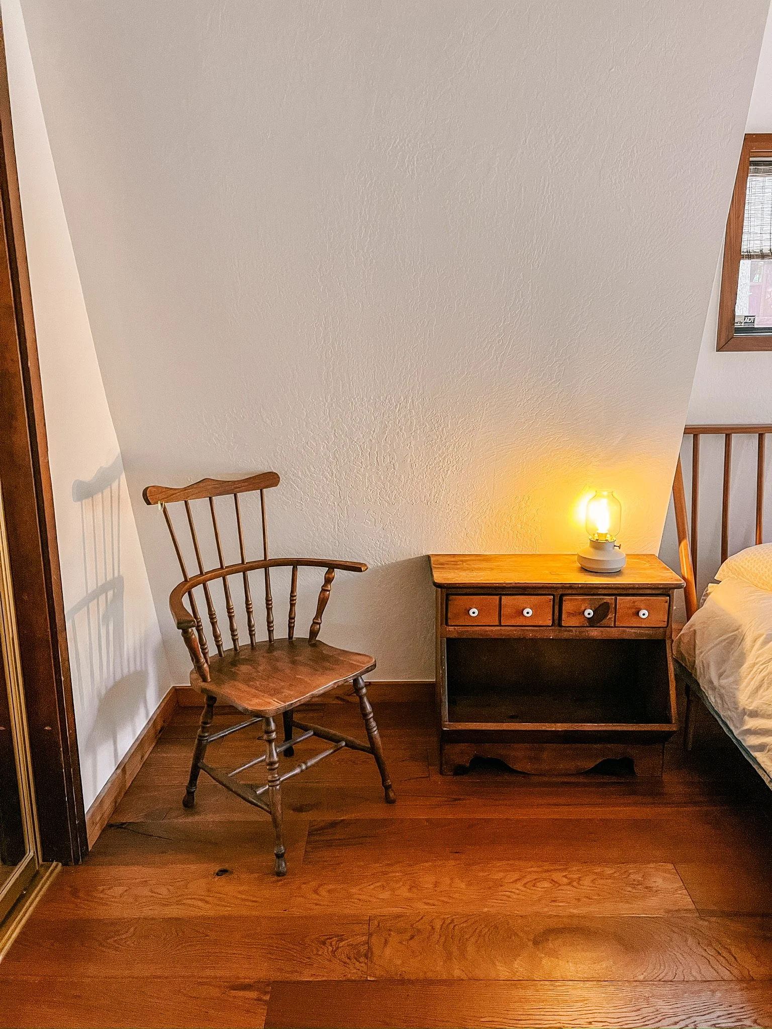 Queen bedroom with antiques, vintage furniture finds and cozy wood floors.