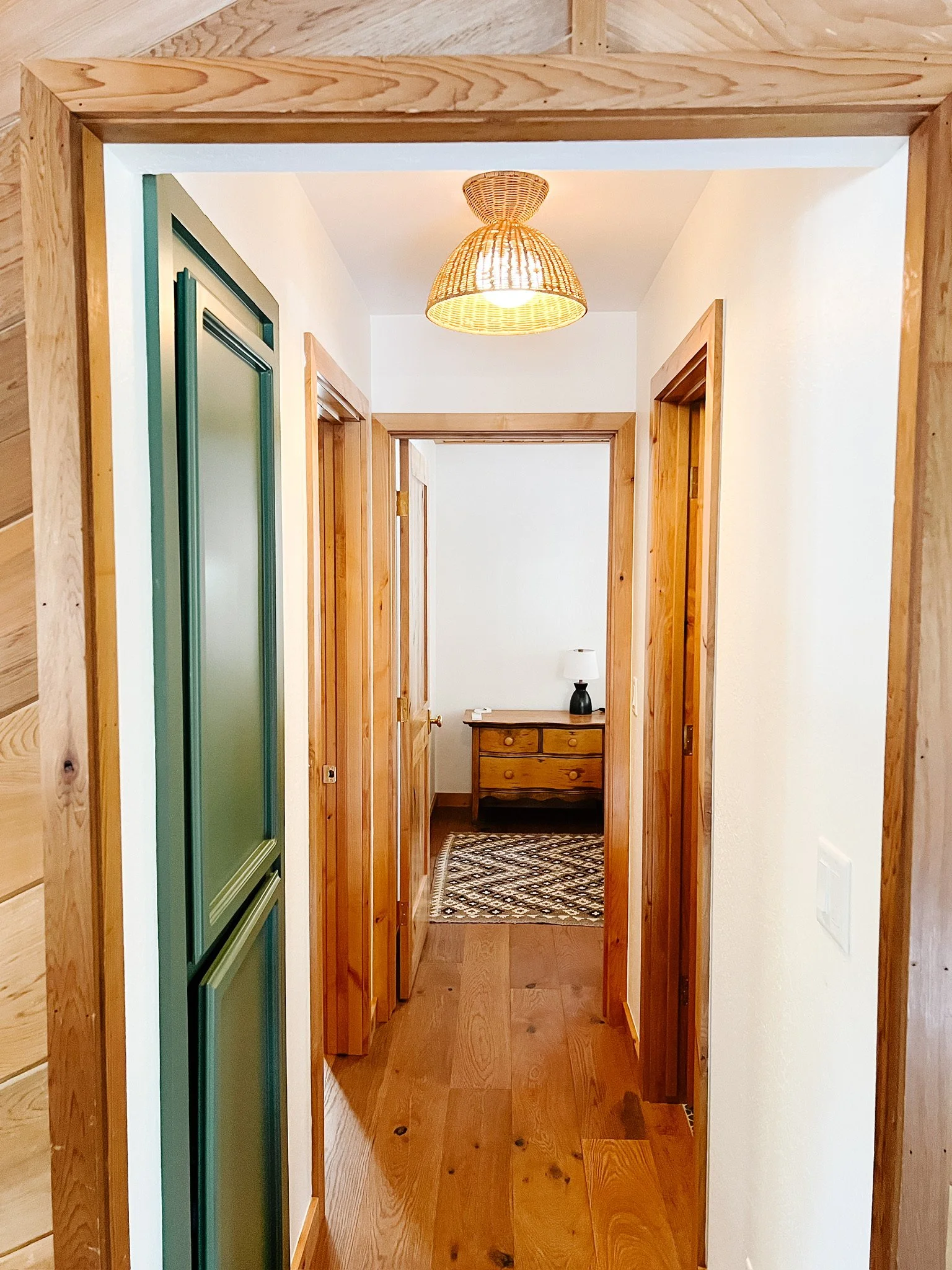 Cabin hallway with new light fixtures and wood floors