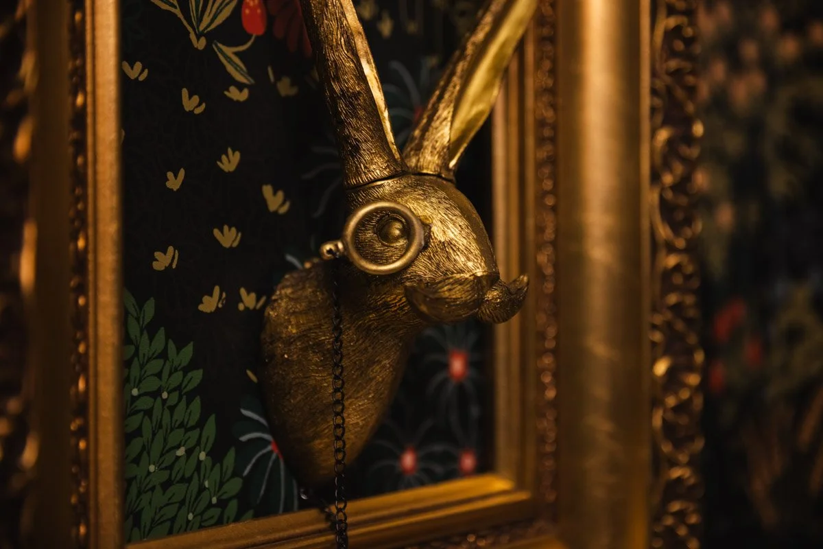 Close up detail of gold rabbit sculpture on wall