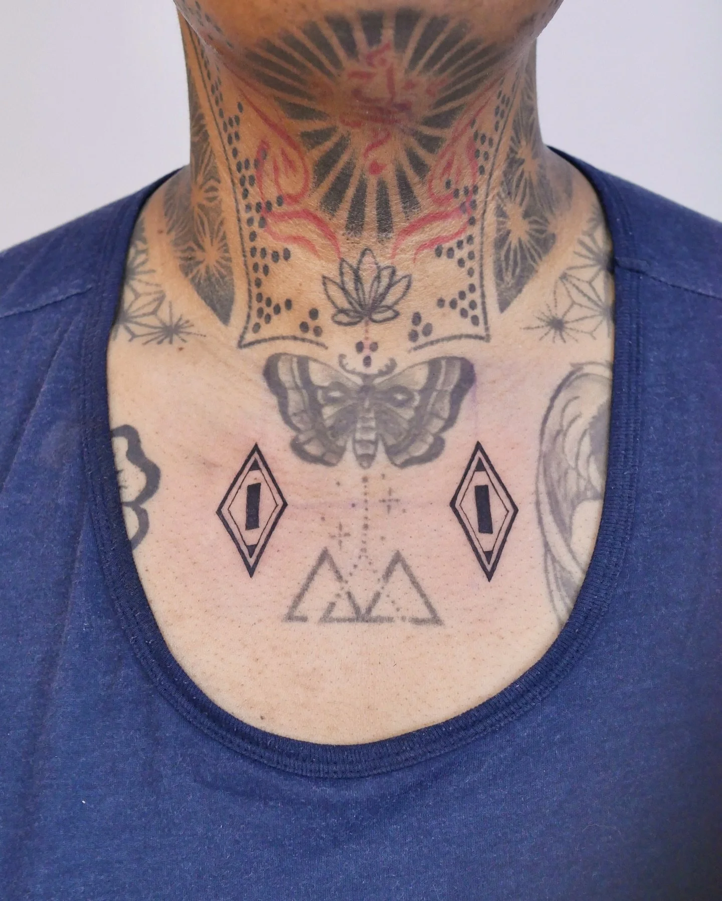 Double symmetrical tattoo on the chest by @ellieic._
