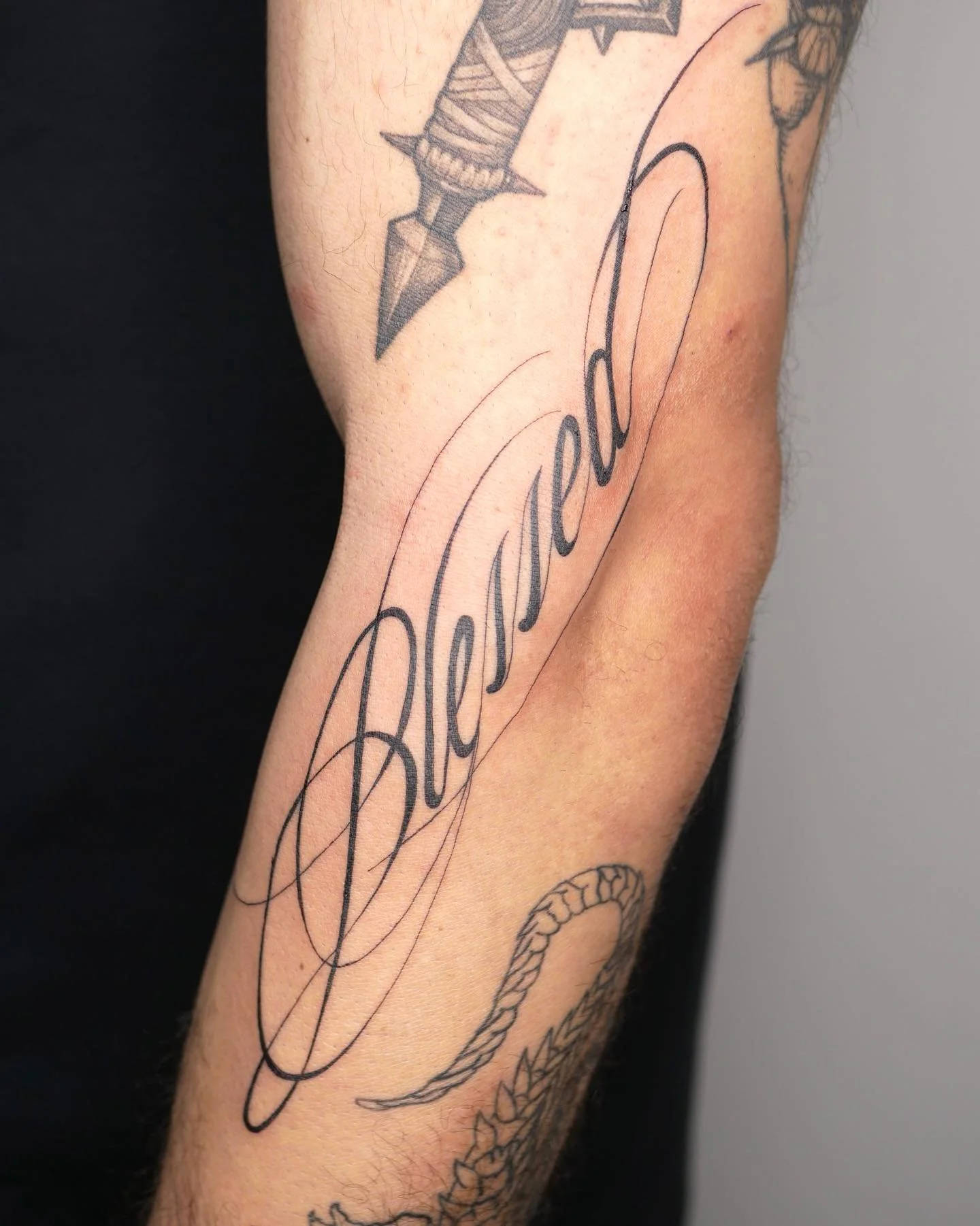 Cursive &ldquo;Blessed&rdquo; tattoo by our Junior Artist Ellie @llama.tattoos on @lessandro.tattoo