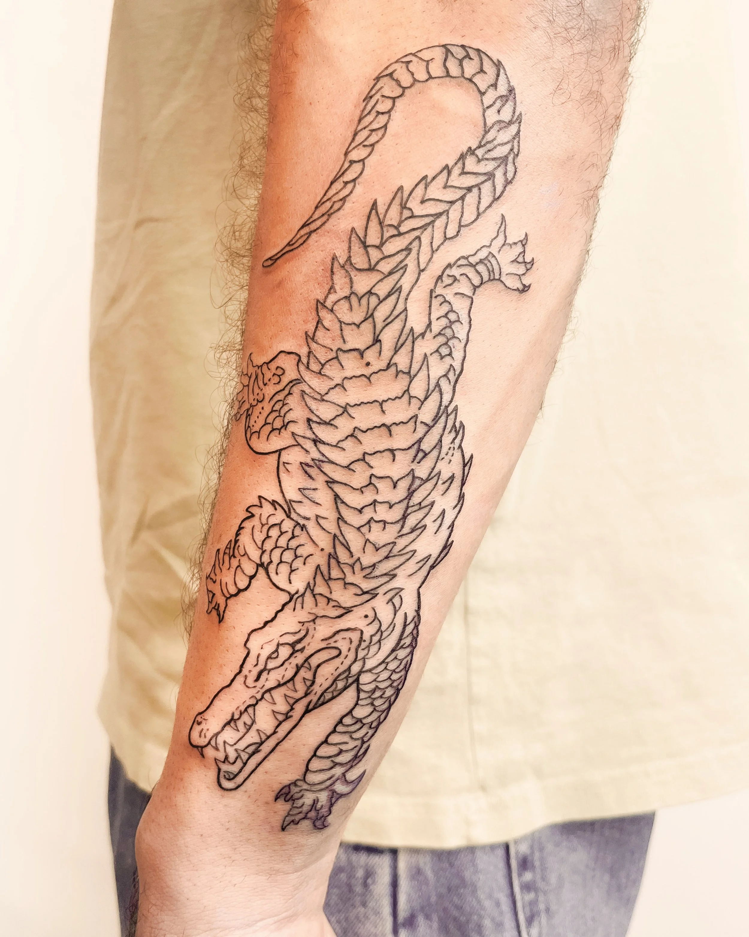 Crocodile tattoo by our junior artist Ellie @llama.tattoos when she first started as an apprentice 🐊

Disclaimer: This design is by Kubi Tattooer and was used for practice on our other junior artist.