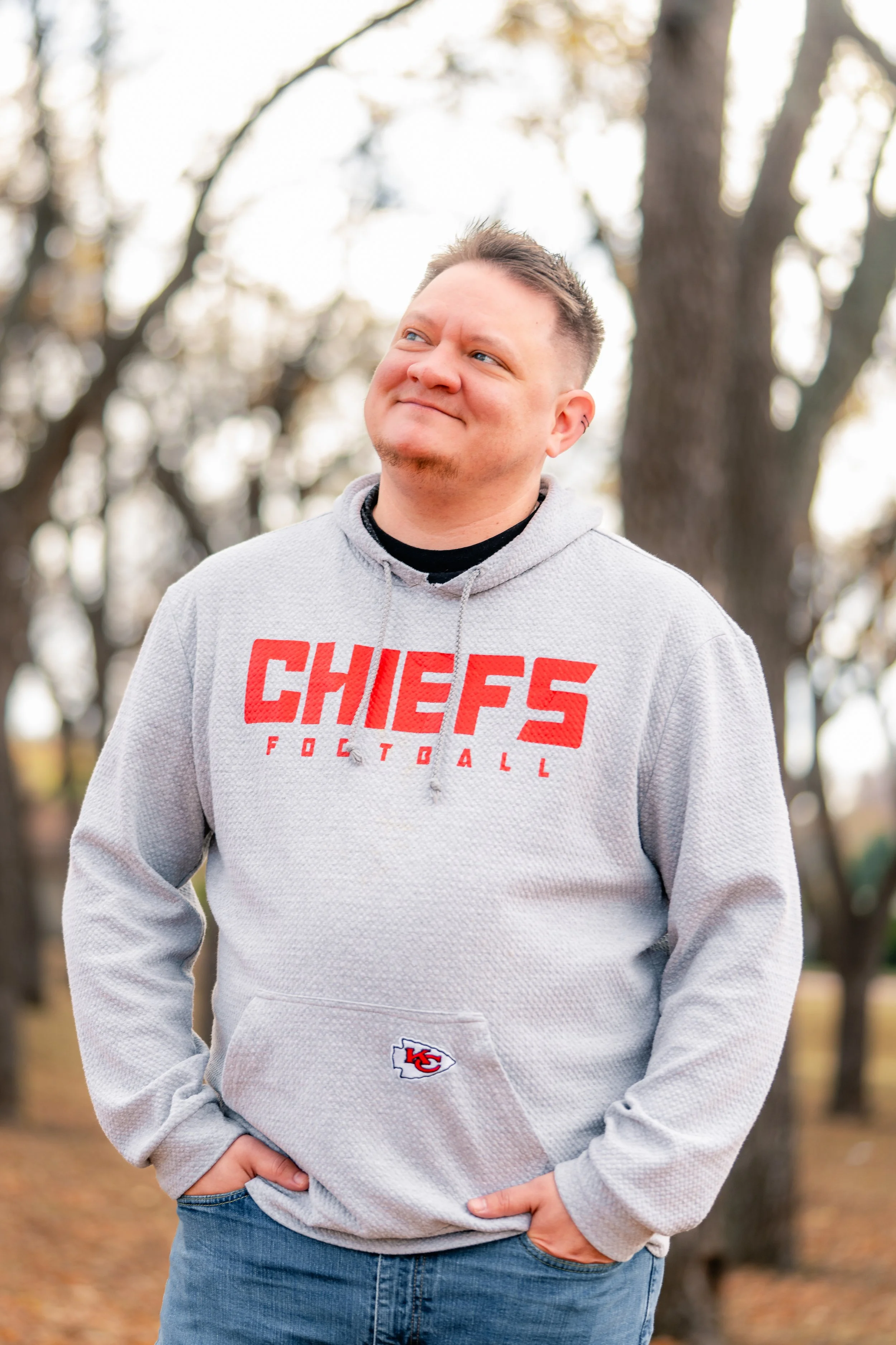 Danny smiles with his hands in his pockets.