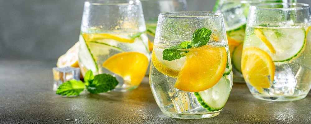 glasses of water with fruit in them