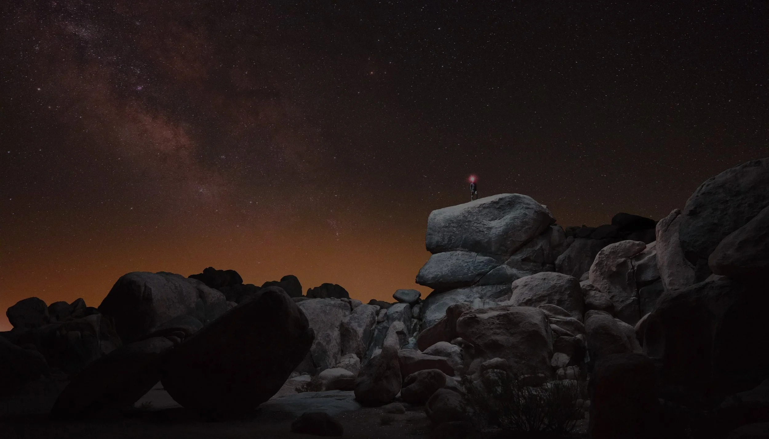 Long-exposure night photograph by Reuben Wu, exploring artificial light across mountainous terrain.