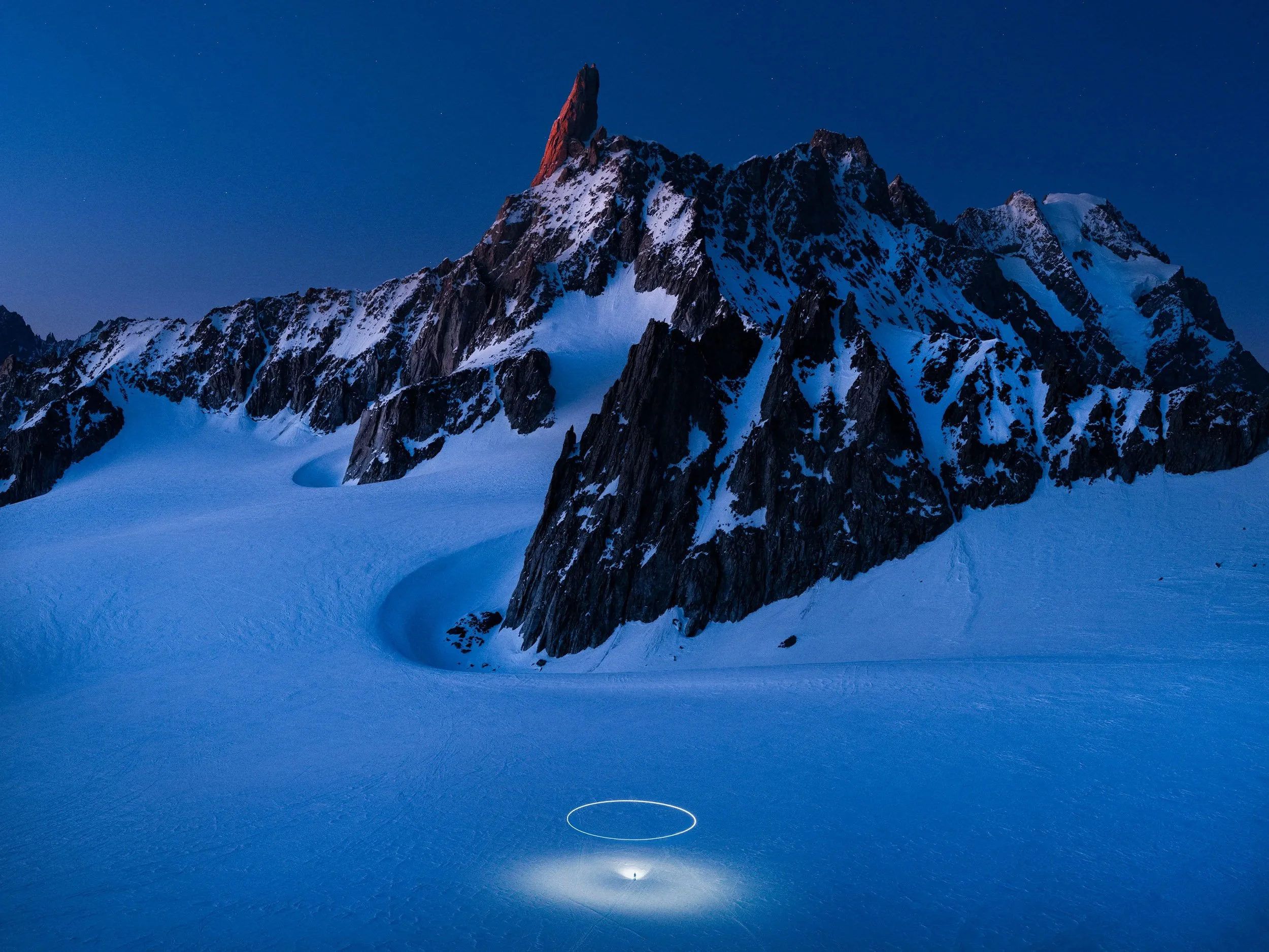 Night landscape photograph by Reuben Wu using drone light to reveal terrain and atmosphere.