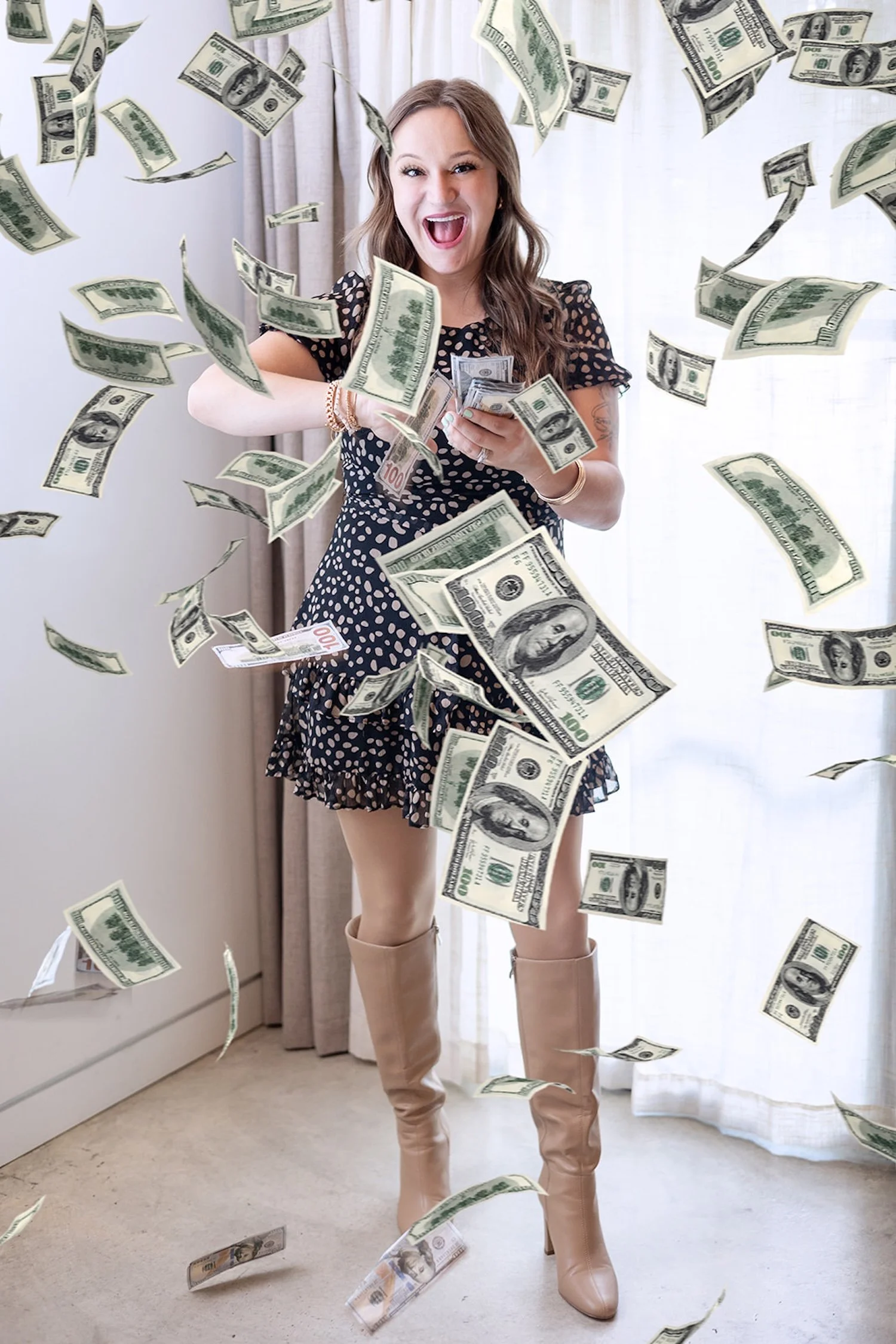 Fractional CMO Morgan Phelps is dressed in a black and white polka dot dress and is excitedly "making it rain" with a stack of $100 bills.