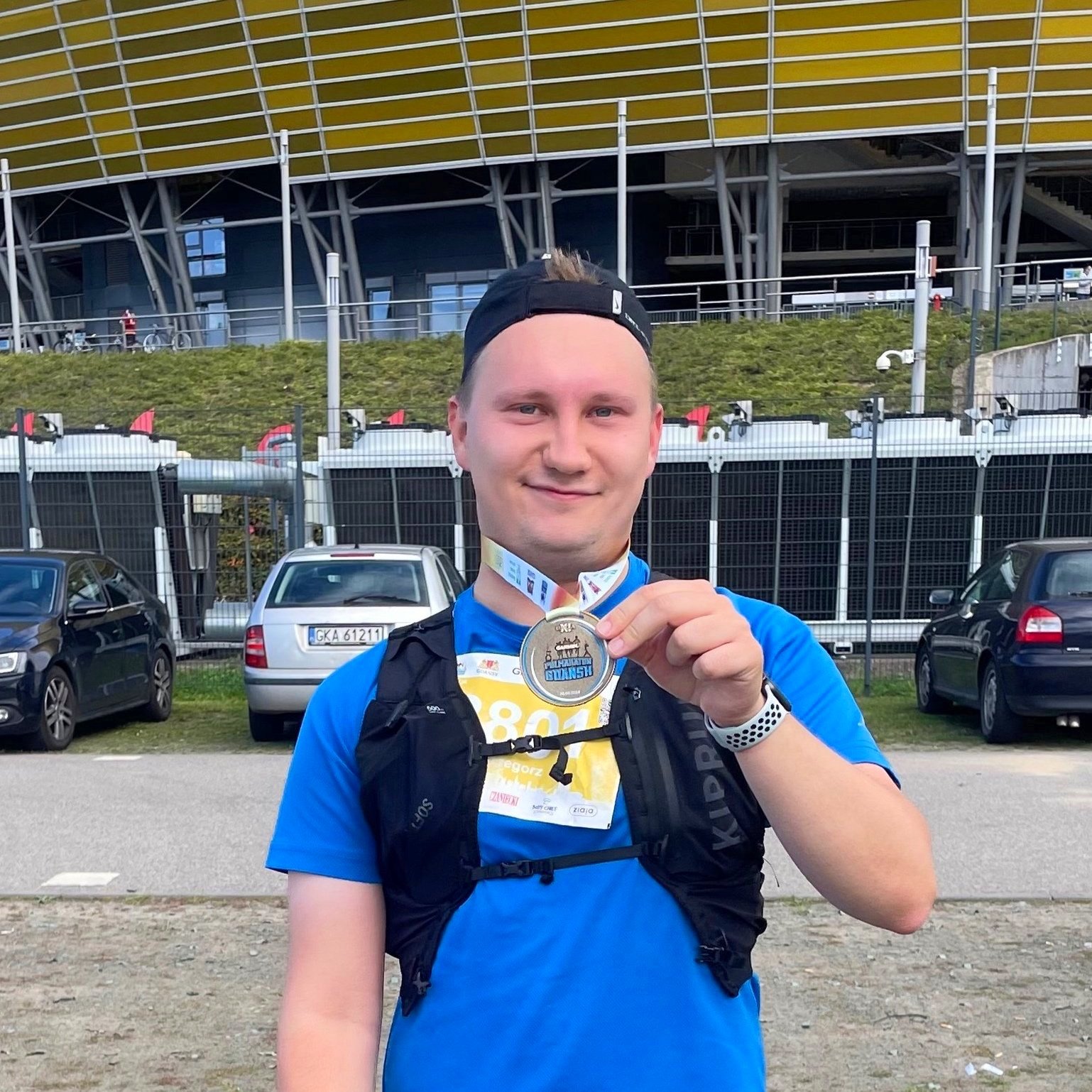 Grzegorz Drozdowski smiling to the camera after his first half-marathon