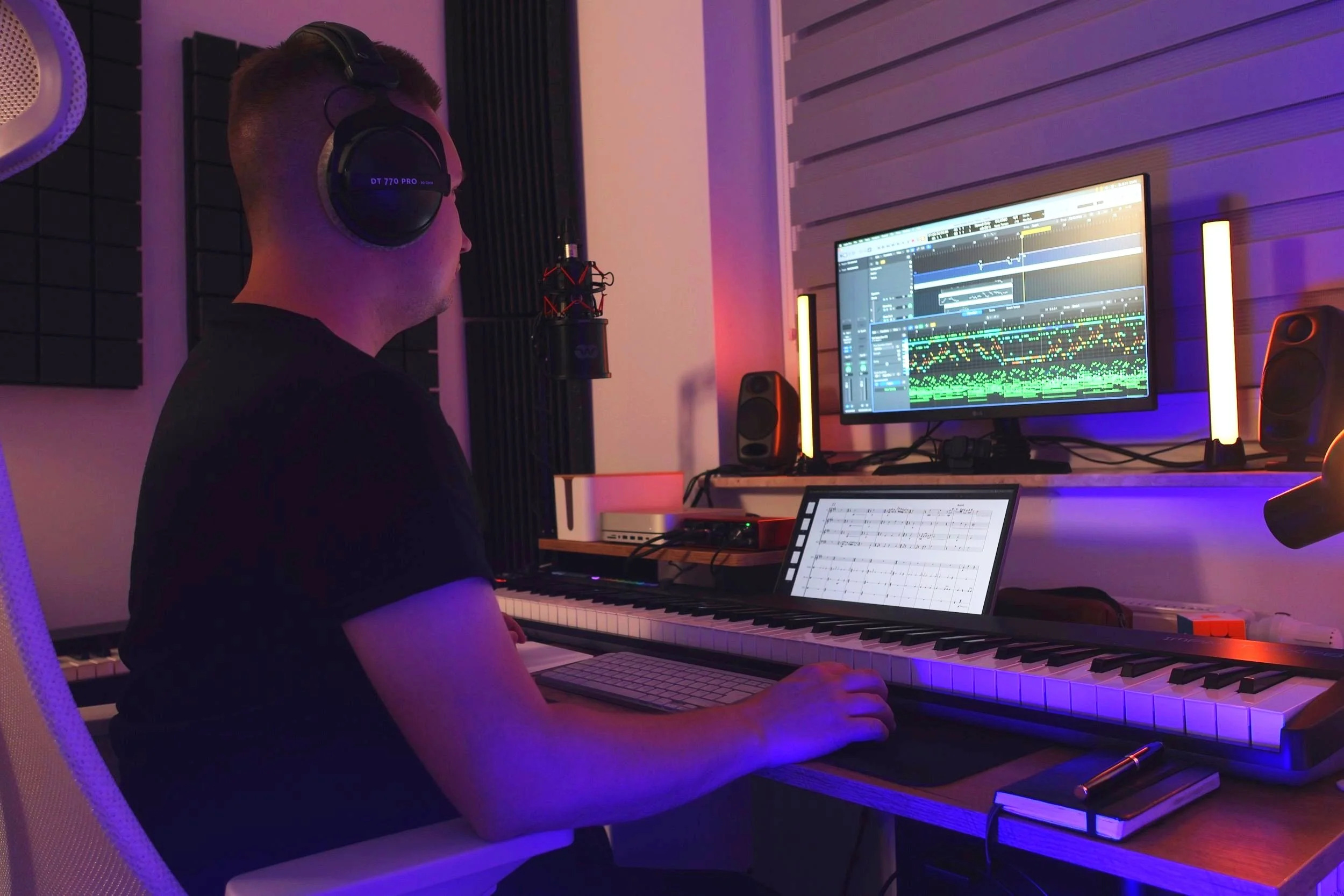 Composer Grzegorz Drozdowski producing orchestral music in a dark home studio