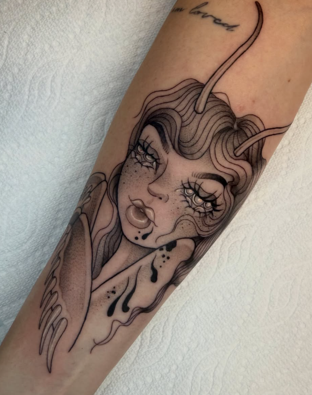 Tattoo of a stylized flower with detailed patterns on the neck and upper chest of a woman with dark hair and piercings.