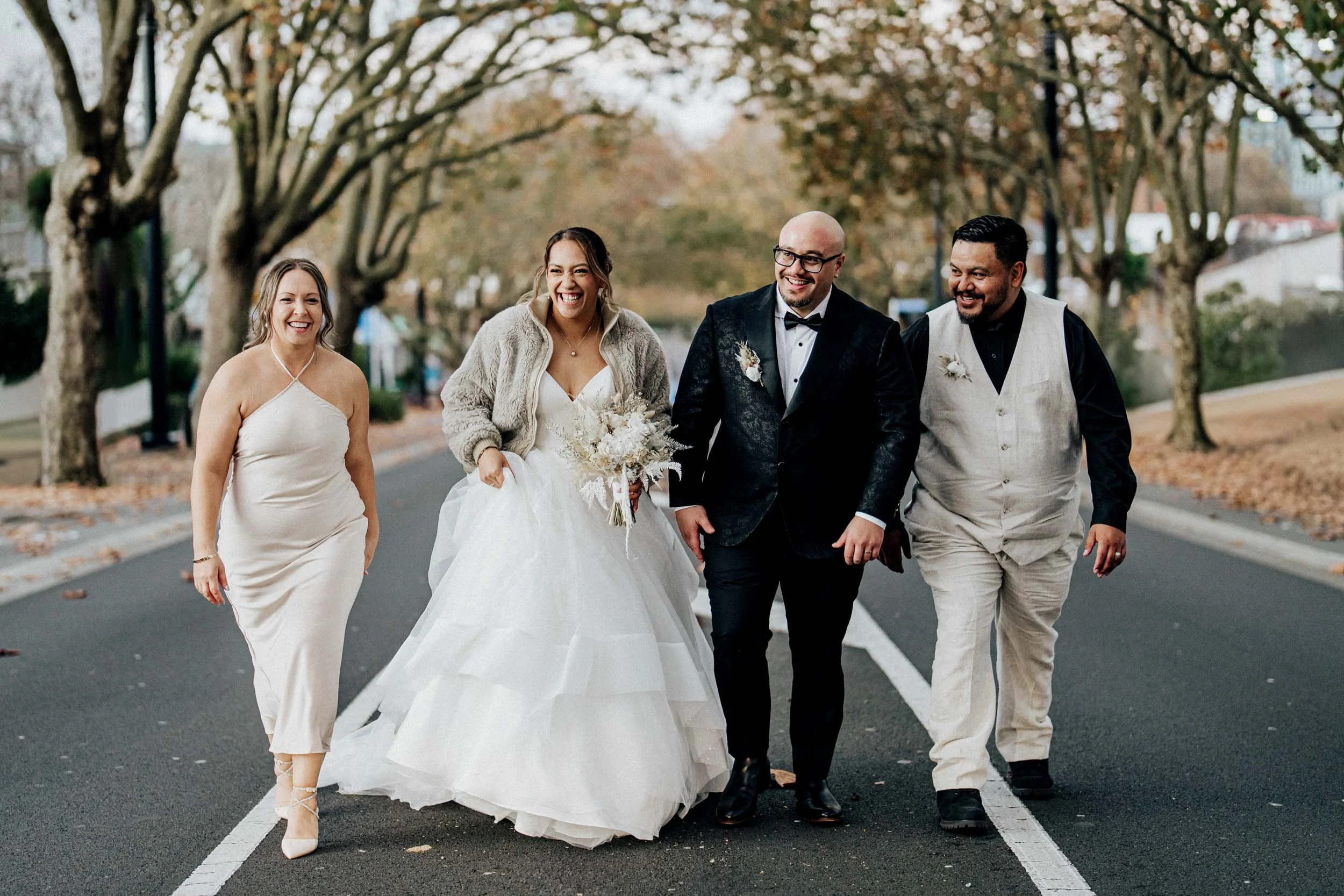Bridal party best friends walking up an urban street in Auckland Autumn