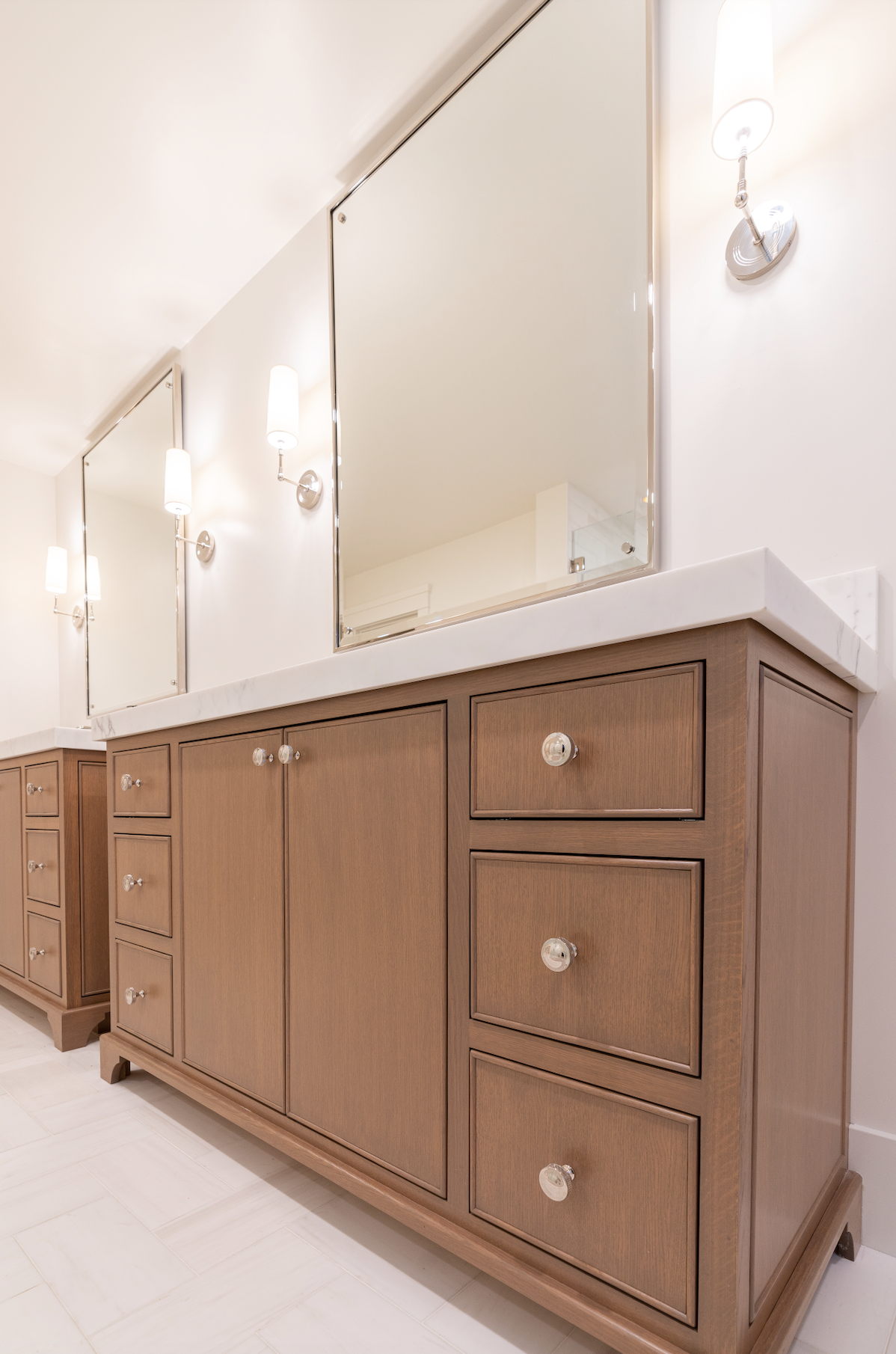 Custom wood bathroom vanity with paneled cabinet doors and built-in storage