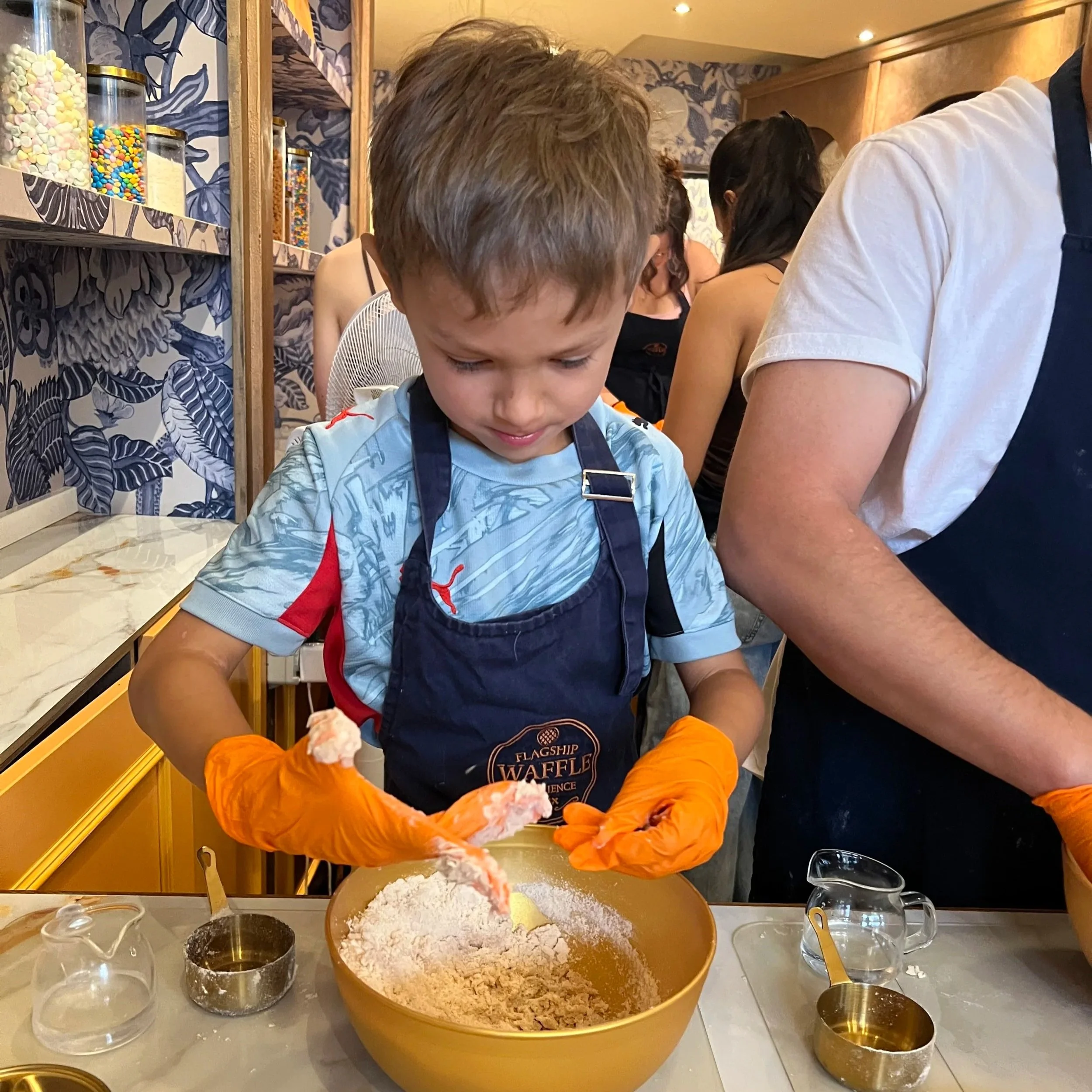 kids making waffles at flagship waffle experience in amsterdam