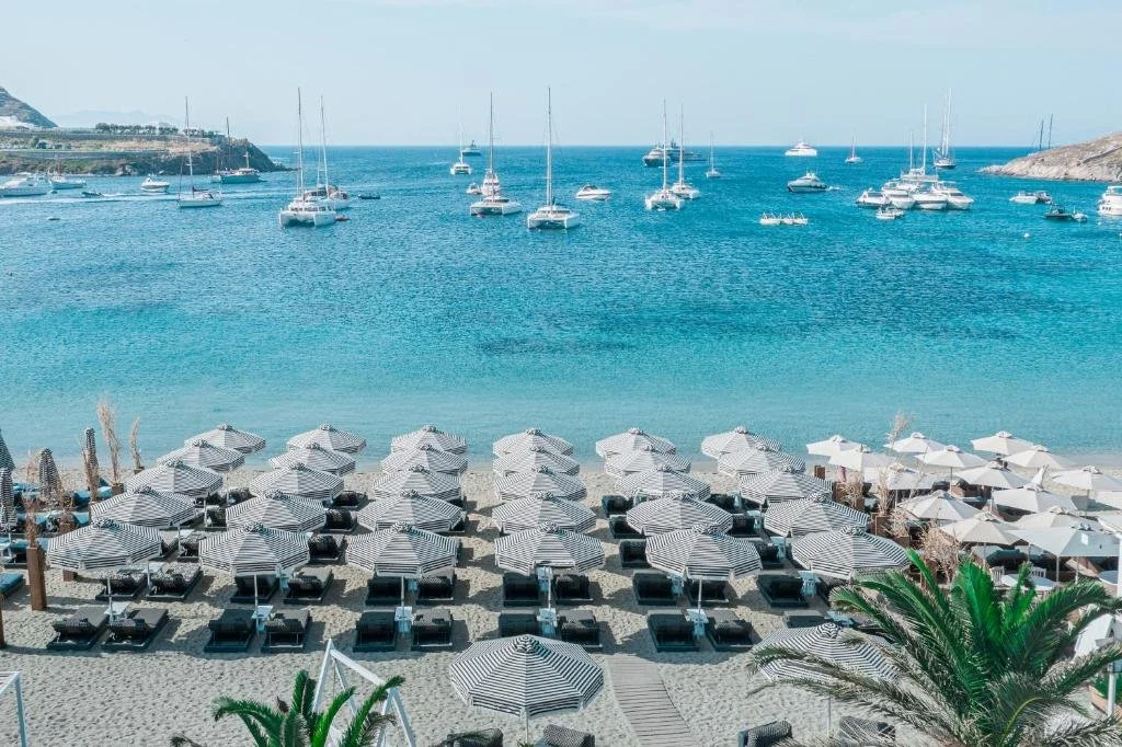 beach area with loungers at Mykonos Ammos hotel in Greece