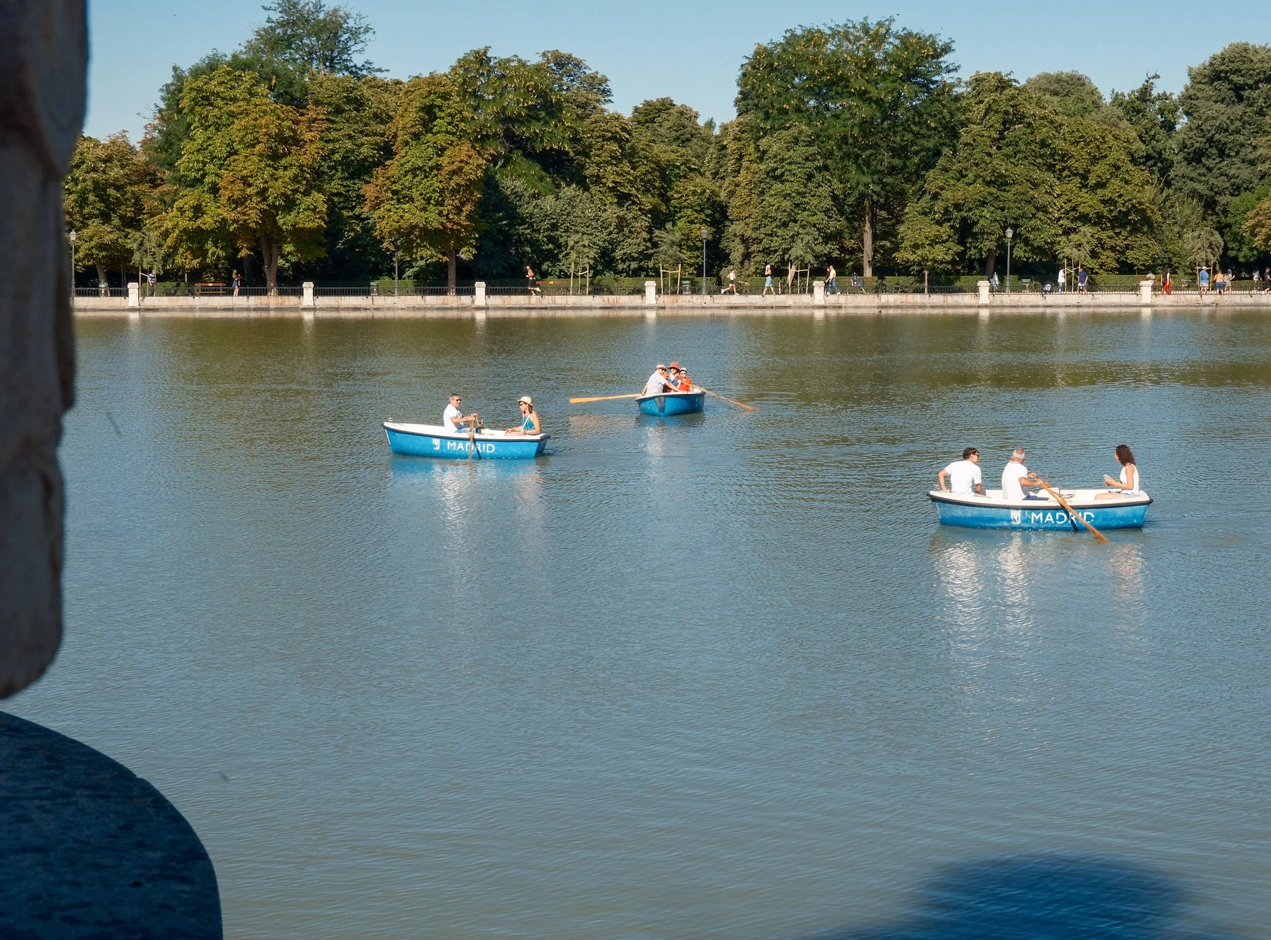 rowboats around retiro park in madrid, spain
