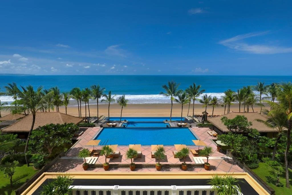 pool and beach at the legian seminyak in bali, indonesia