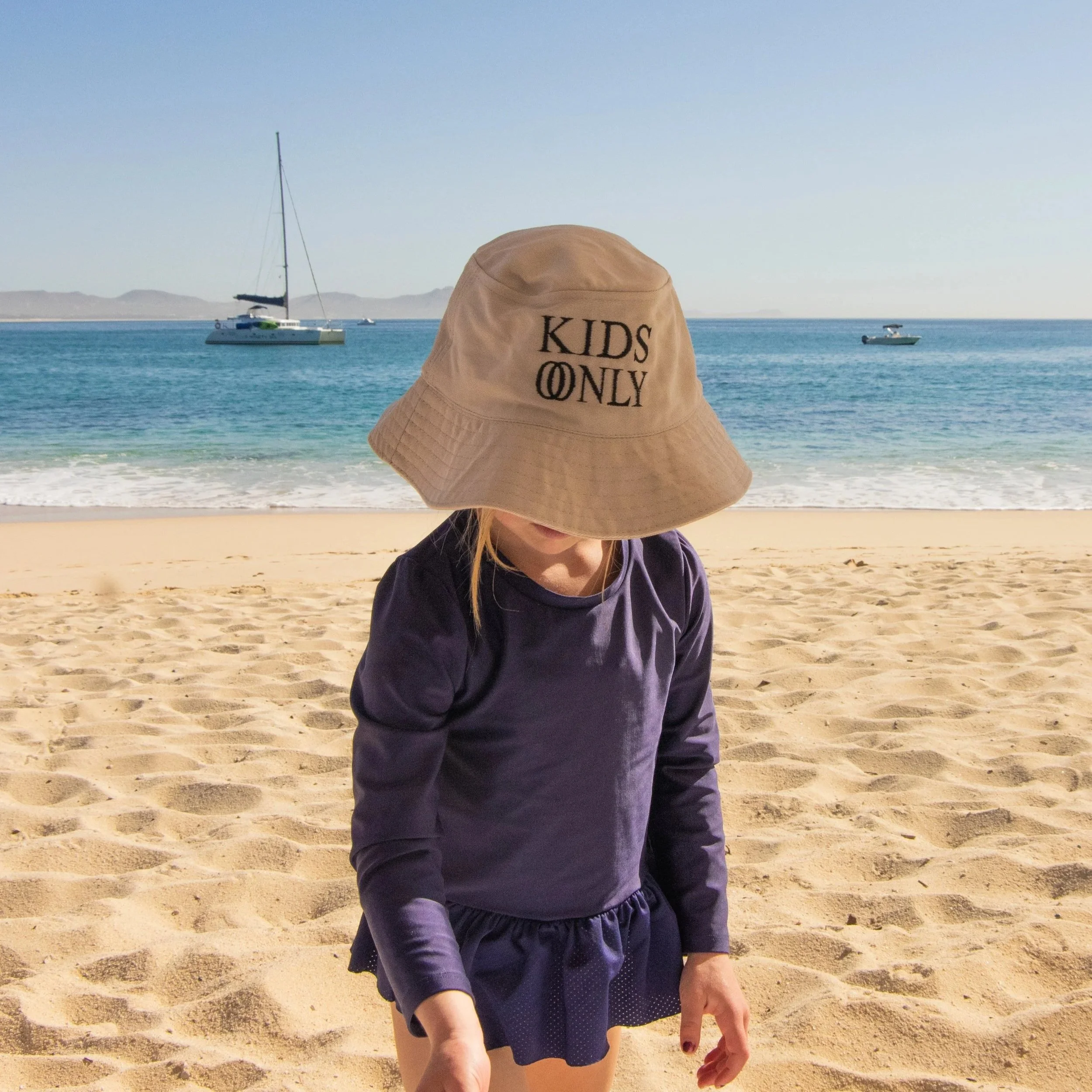 our daughter playing on the beach in front of one and only palmilla in cabo san lucas