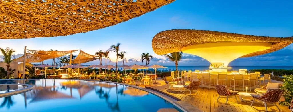 pool and bar at dusk at the palms turks and caicos on grace bay