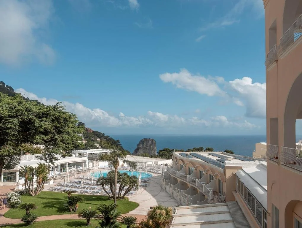 view from balcony at hotel quisisana overlooking pool and bay in capri italy
