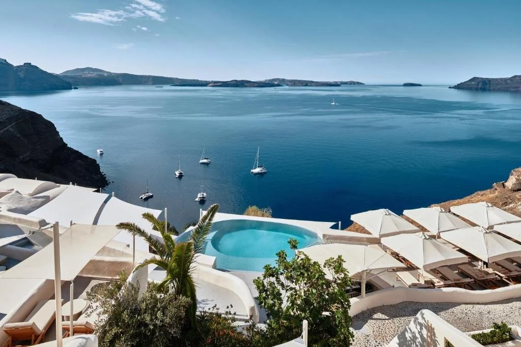 pool overlooking caldera at mystique in santorini greece