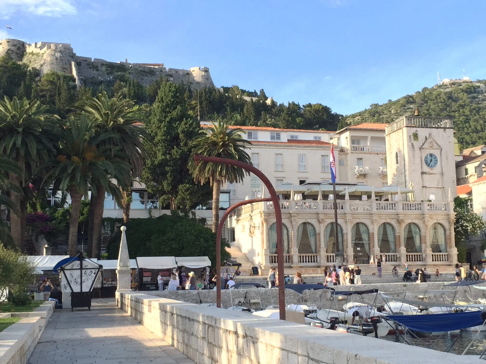 hvar port in the afternoon with the military fortress above