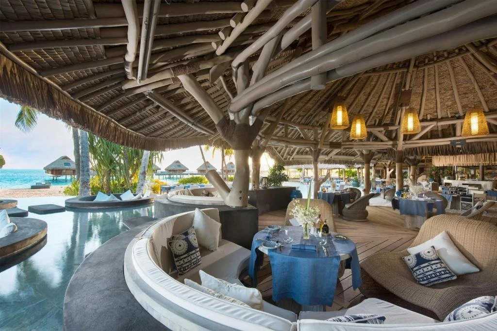dining area overlooking pool and beach at conrad bora bora nui in french polynesia
