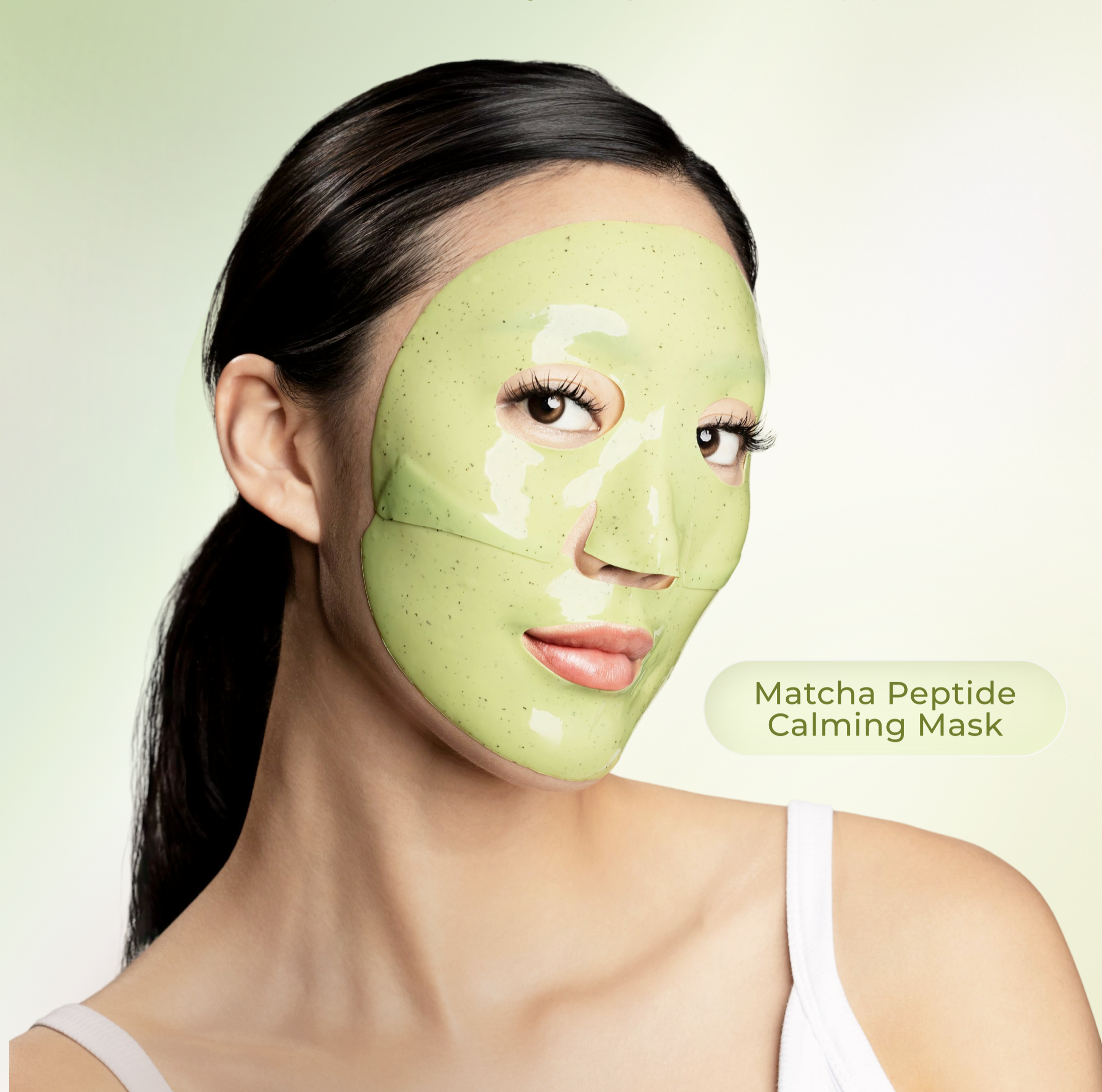 Woman wearing a green matcha peptide calming face mask