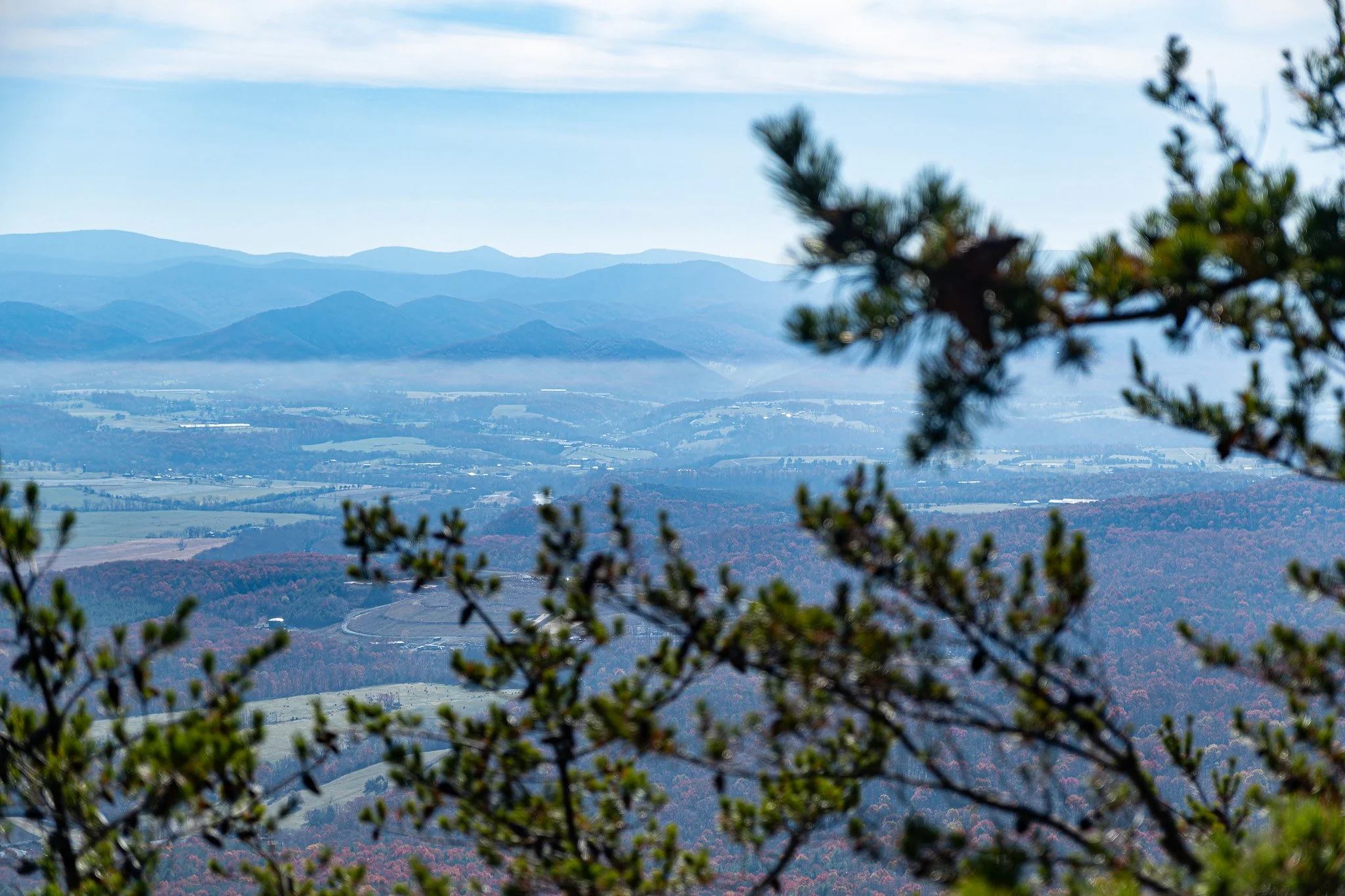 A beautiful view of the mountains opening up from the evergreens on the Storybrook trail.