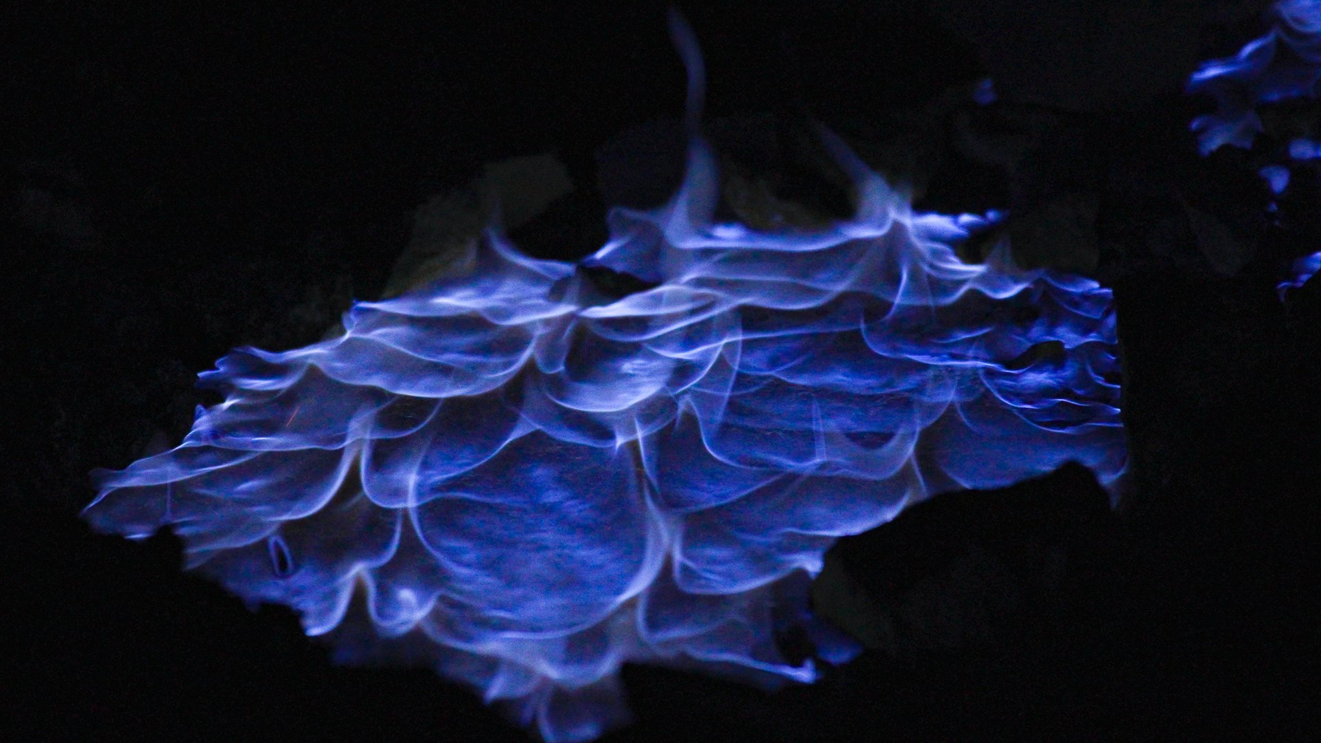 The ignited gases "run" down the side of the volcano and collect into pools of burning gases