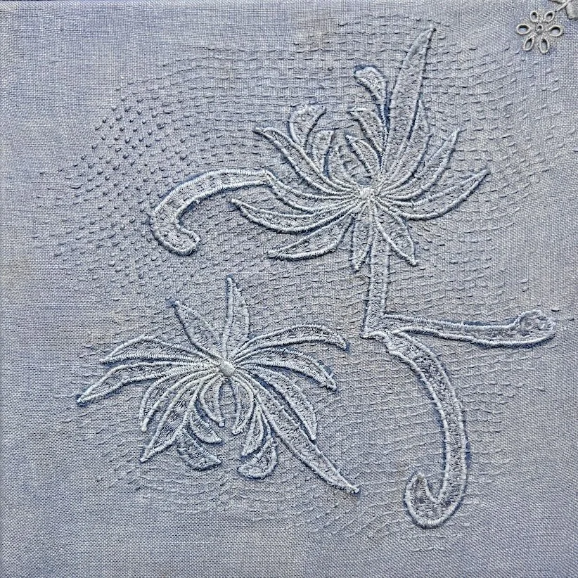 Still Becoming 2026 
Hand-dyed silk lace fragments from a vintage lace collar appliquéd on hand-dyed vintage serviette with hand stitching.
Lace flowers  rest within patient stitch, suspended between fragility and renewal. The surface suggests quiet 