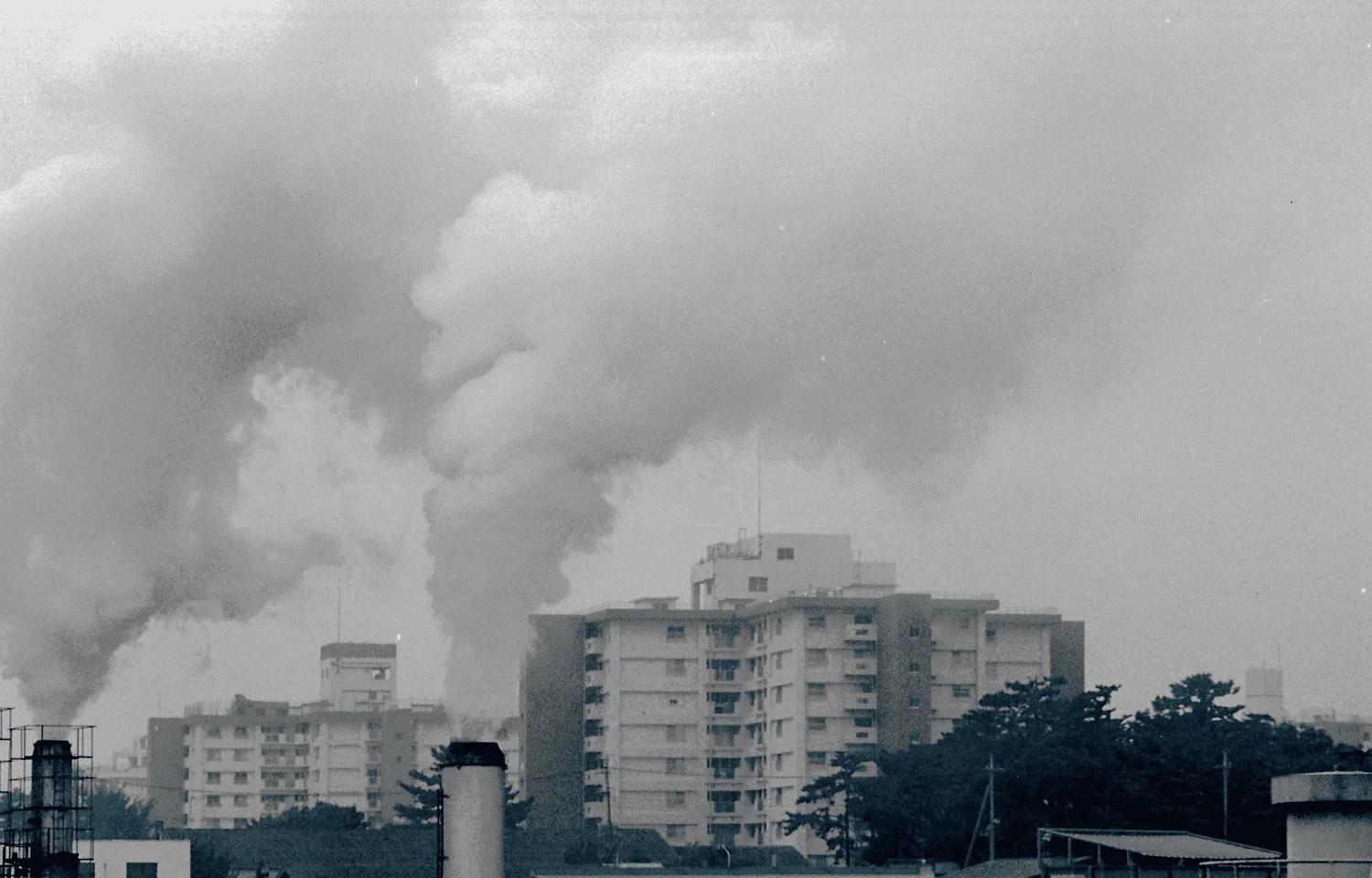 Residential Towers Visible Beyond the Smokestacks