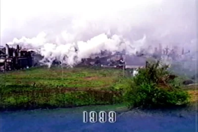 Atsugi incinerator emitting thick clouds of opaque white smoke, fumigating a nearby military residential tower.