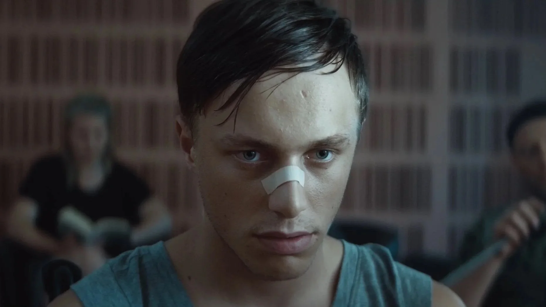 Still from the iCarus cinema trailer: a young man with a bandaged nose.