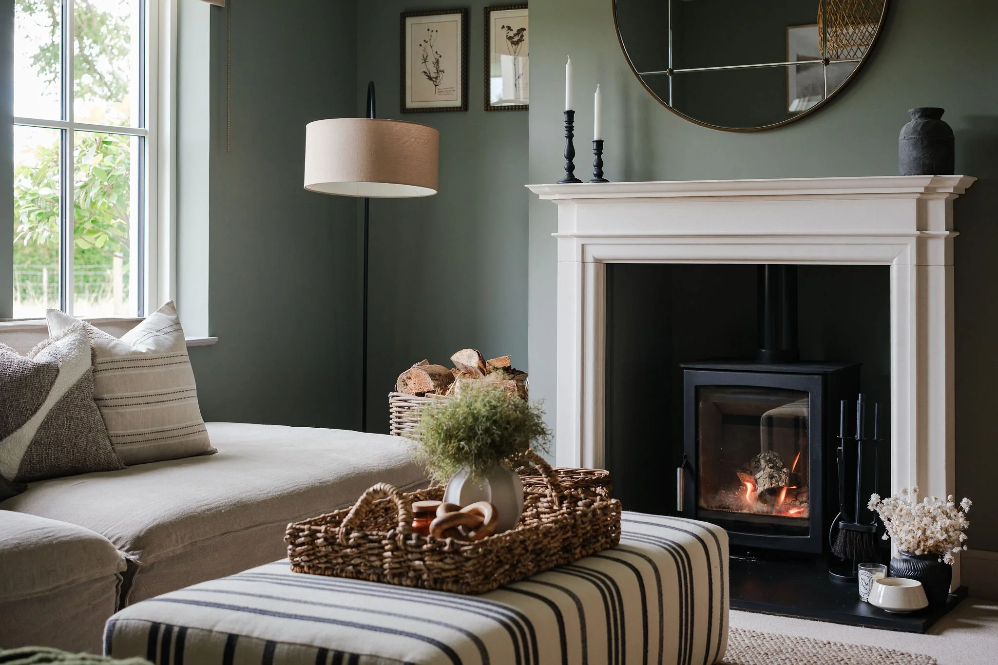 Green living room with striped footstool