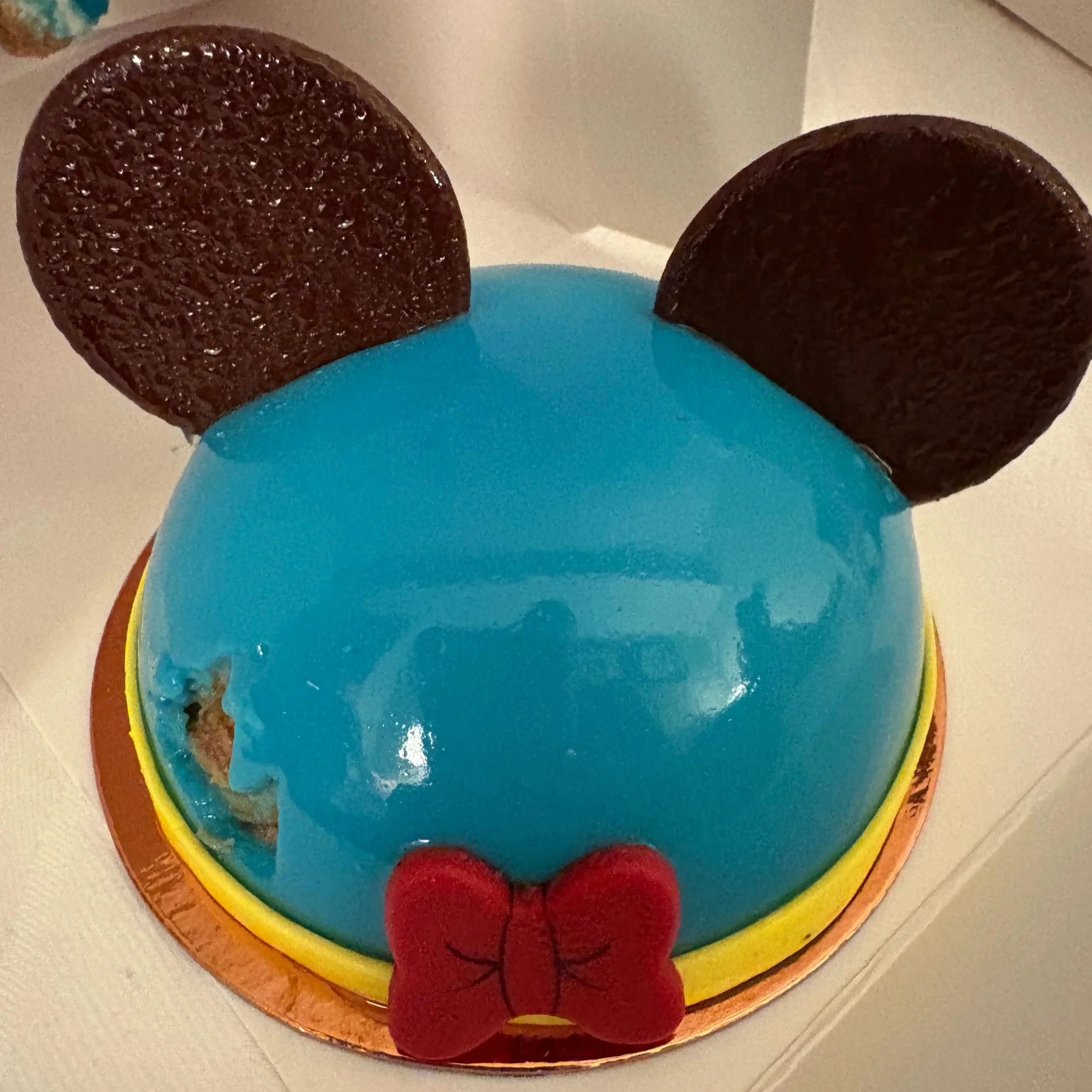 The Donald Duck cake from Amorette's Diner at Disney Springs - typical Donald colours of red box, yellow outline and bright blue icing.