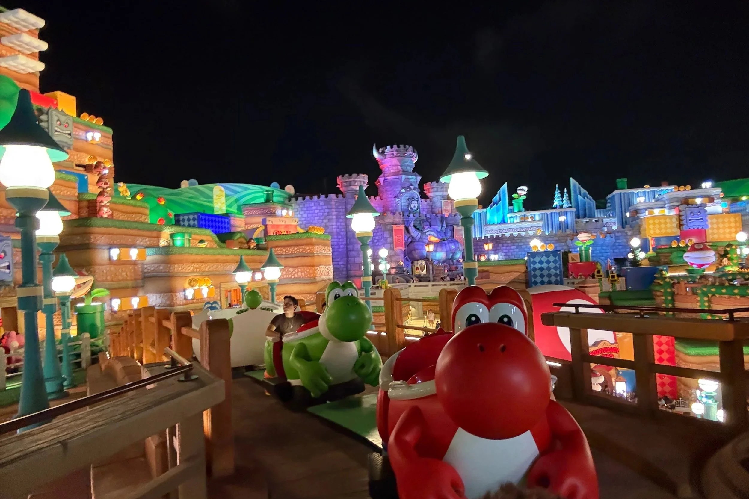 Yoshi's adventure ride, at night all lit up like a rainbow.