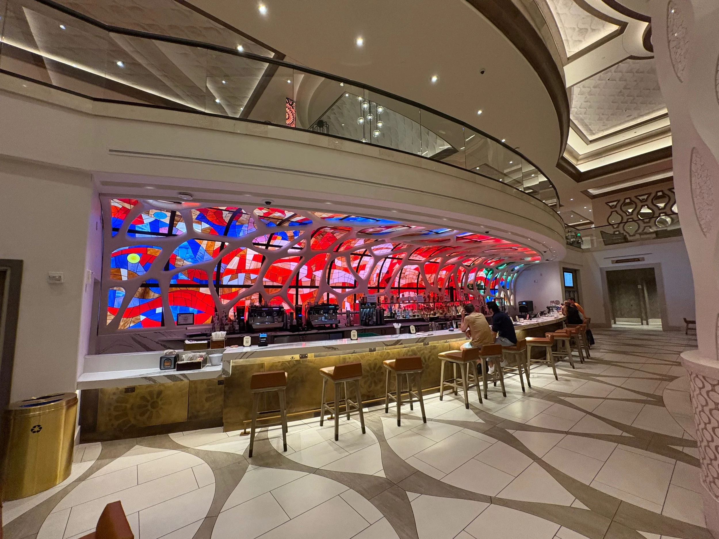 Image of the Barcelona Lounge.  A bar at the Gran Destino Tower, Coronado Springs with pinks blues and in that typical Gaudi style
