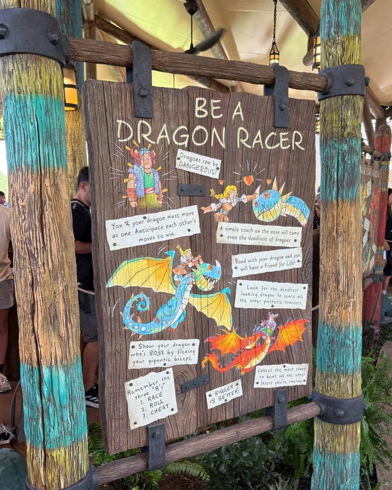 One of the playful signs in the line of Dragon Racers, Epic Universe on how to train your dragon.