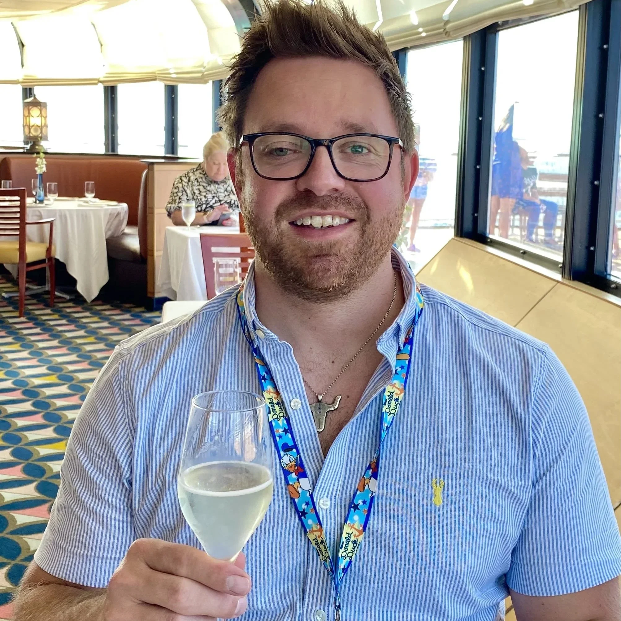Wayne at Palo on the Disney Magic with a glass of champagne