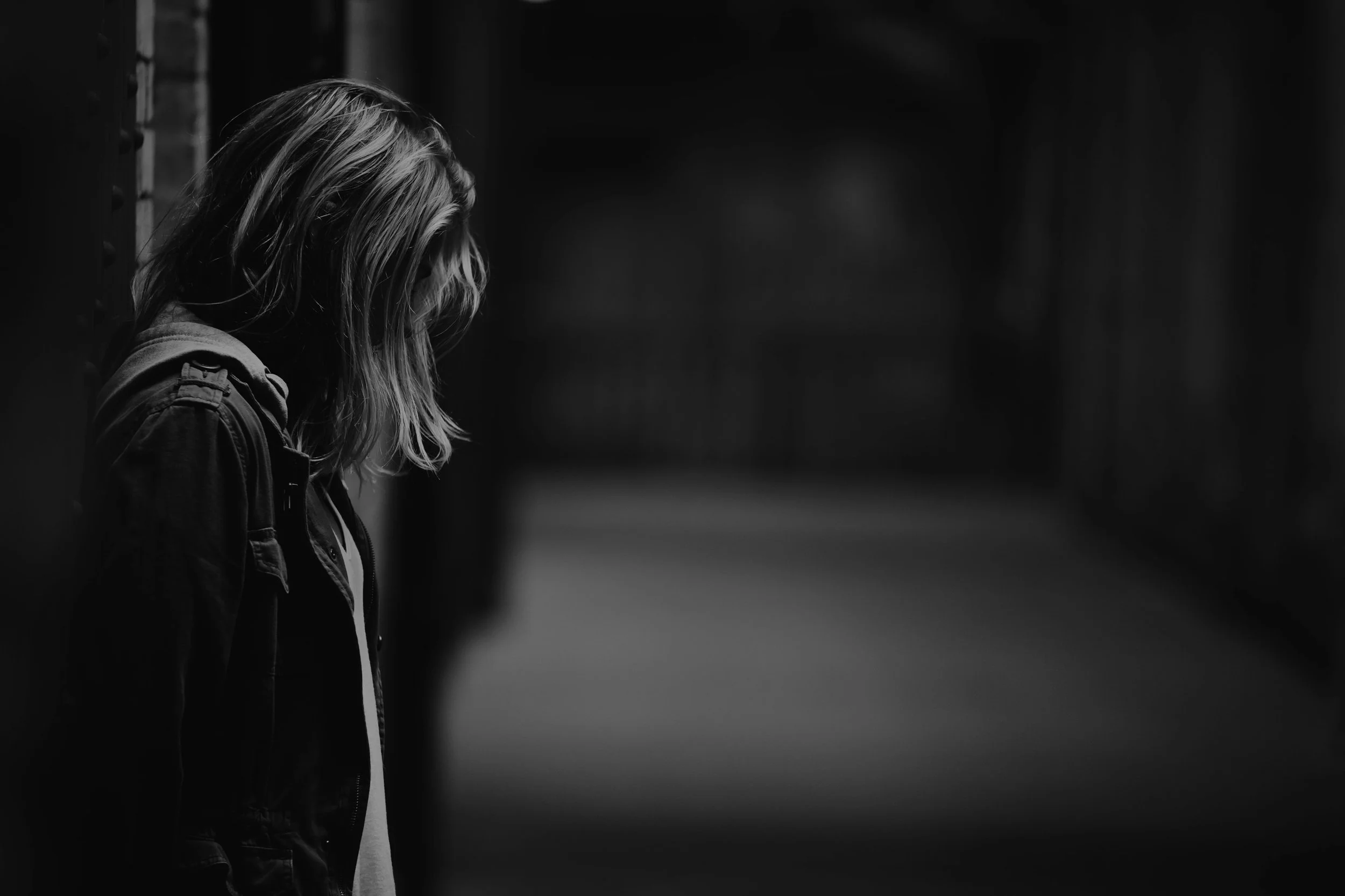 Greyscale image of an adolescent girl looking down